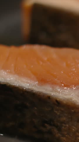 Vertical Video of Soy Sauce Being Poured onto Salmon Fillet Cooking in Hot Pan.