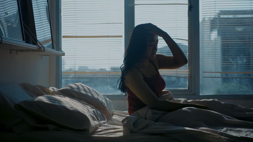 Beautiful asian woman smoothing her hair to prepare lying asleep enjoying healthy good sleep nap. Young woman sleeping well in comfortable cozy fresh bed on soft pillow white linen.