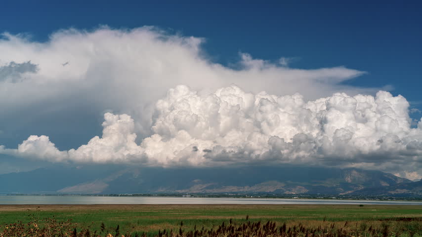 Time lapse of clouds moving over Timpanogos Mountain looking across Utah Lake from Sandy Beach.