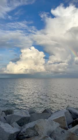 A rainbow in the clouds over the sea