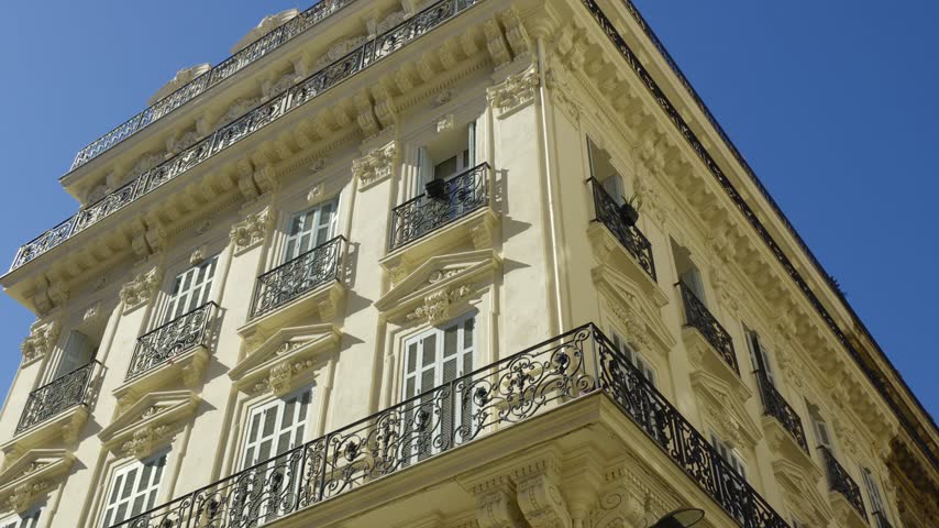 Low angle view of a classic Haussmannian style building with ornate balconies in Marseille