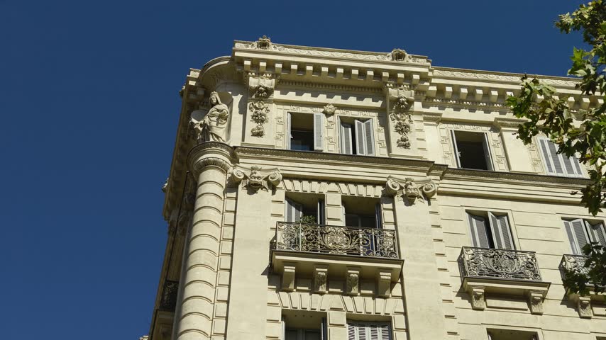 Beautiful low angle view of an old apartment building with ornate balconies in Marseille, France