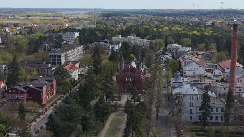 Aerial view of the red brick neo-Gothic church and historic buildings in Ciechocinek town, Poland