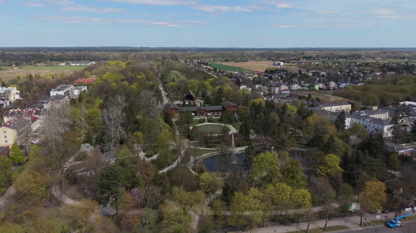 Wide aerial view of the Zdrojowy Park with its fountain and lush greenery in Ciechocinek, Poland
