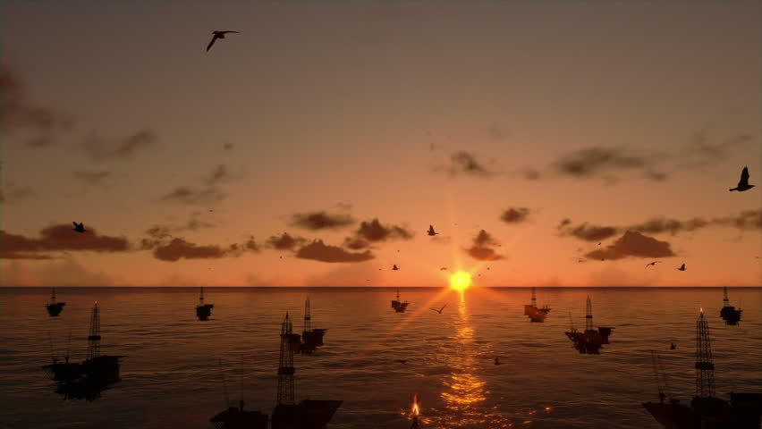 Oil rigs in ocean, time lapse sunrise, camera tilt