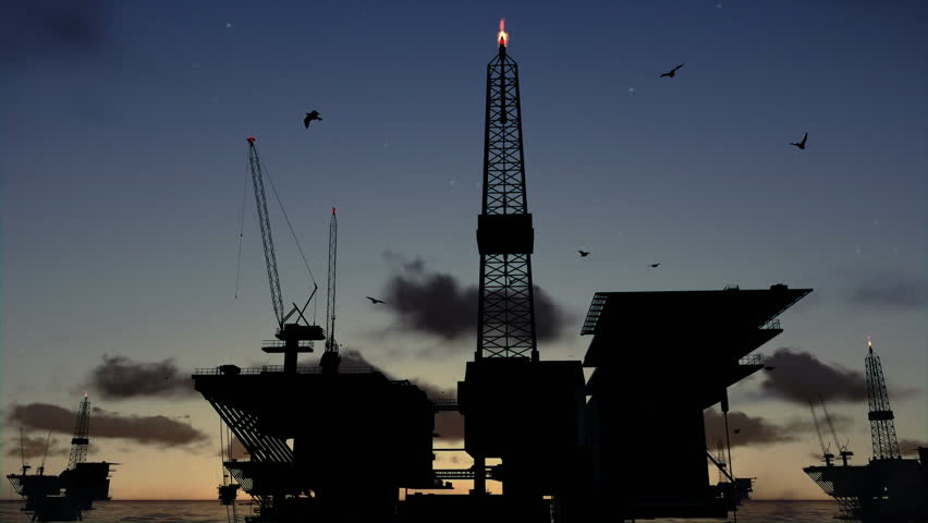 Oil rigs in ocean, time lapse sunrise night to day silhouette 