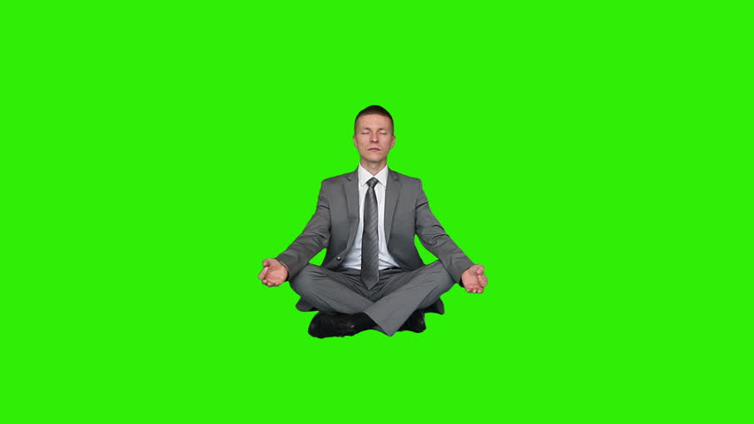 Young businessman meditating, Green Screen