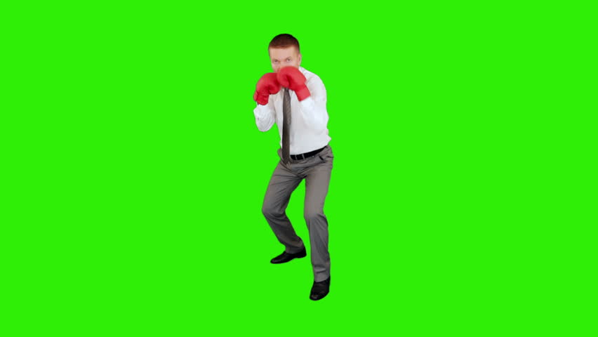 Young businessman boxing and hitting himself, Green Screen