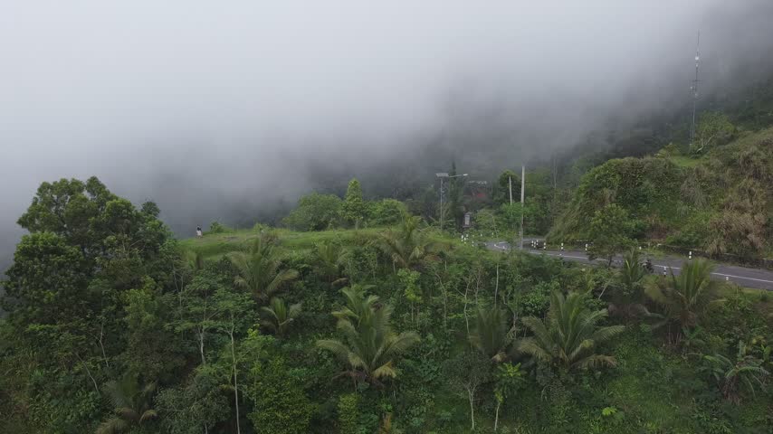 Highway over the mountains covered in thick fog