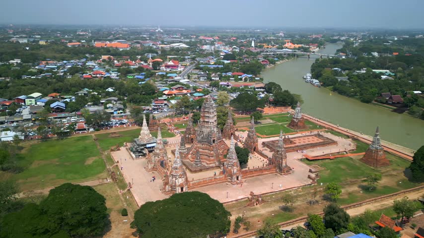 Aerial view of Wat Chaiwatthanaram in Ayutthaya, Thailand. Historic Buddhist temple and UNESCO World Heritage Site beside the Chao Phraya River showcasing ancient Siamese architecture.
