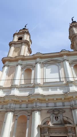 Vertical low-angle view of the former Church of San Francesco di Paola in Parma, Italy, highlighting its symmetrical Baroque façade and twin Torri dei Paolotti.