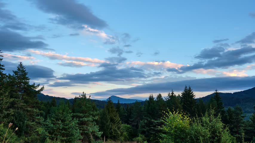 Timelapse Of Clouds Moving Over Pine Forest And Mountains At Sunset, zoom in
