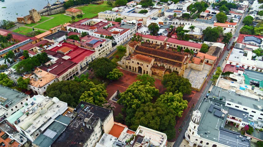 Historic square in Santo Domingo featuring old houses and medieval-style buildings. Beautiful cityscape, aerial view. Classic Dominican cityscape on an overcast day.