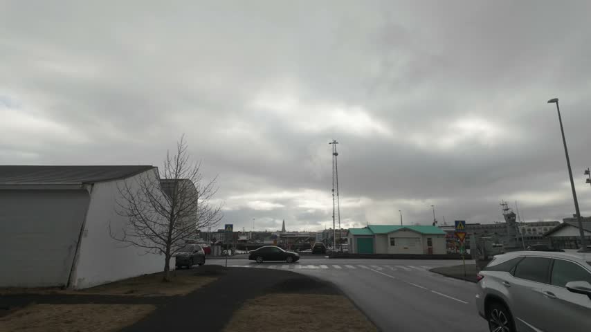 Cars driving on the roads of Reykjavík in a neighborhood.