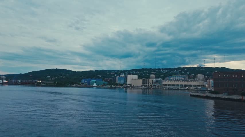 A view of Duluth Minnesota from the harbor under a cloudy sky.