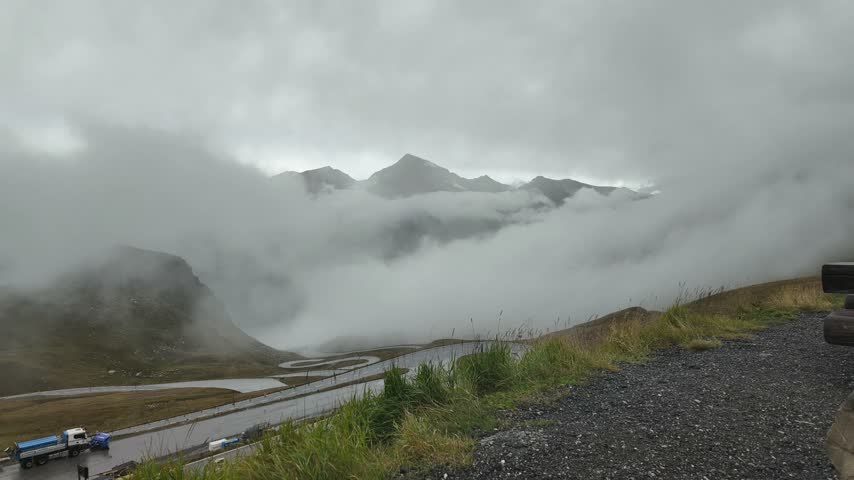 Grossglockner Mountain in the Austrian Alps, Beautiful View. Mountain peaks surrounded by moving clouds during overcast weather. Scenic alpine landscape in Austria.