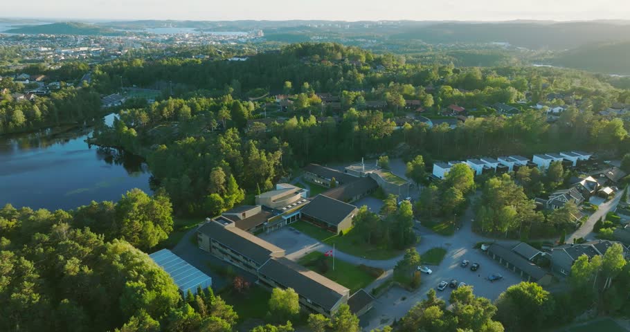 Aerial view drifting past housing blocks beside a lake at Gimlekollen in Kristiansand, Norway