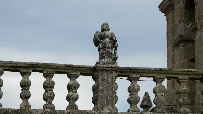 Stone statue and balustrade at San Pedro de Moreiras church in Toen, Ourense, Galicia, Spain