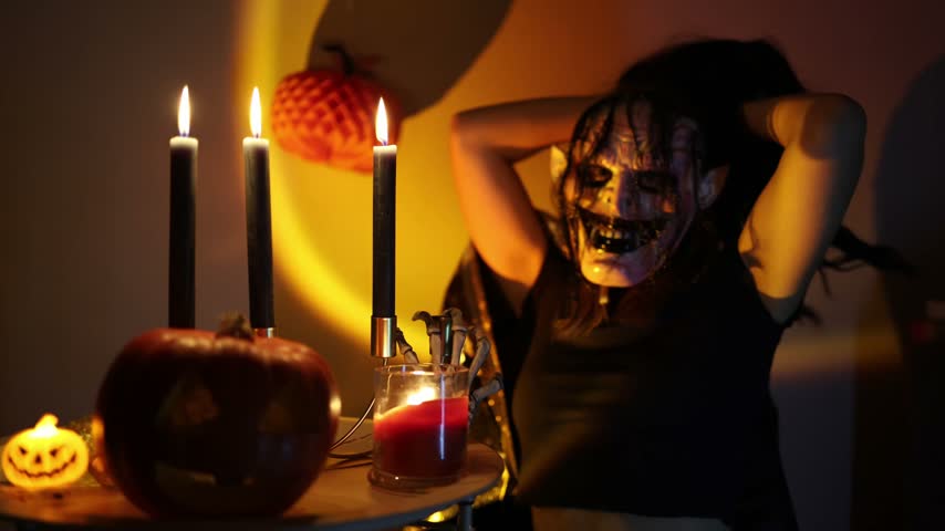 Halloween night inspires people to hide behind frightening masks and become creepy fantasy characters as part of an annual tradition of costumes pumpkins and candlelight