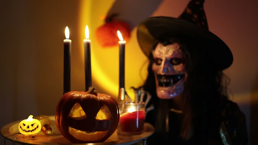 Halloween night inspires people to hide behind frightening masks and costumes as an old holiday tradition bringing spooky characters to life among pumpkins and candlelight