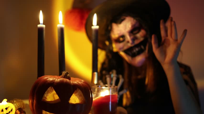 Halloween tradition brings people into frightening costumes every year as they transform their appearances for a spooky celebration filled with masks pumpkins and candles