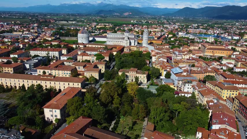 Majestic aerial view showing the botanical garden and museum of pisa with the famous leaning tower and cathedral in the background