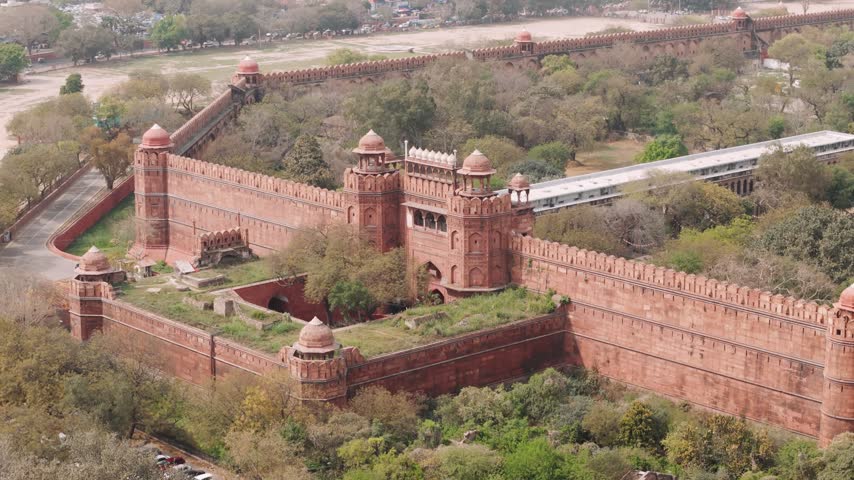 Aerial view of the historic red fort in delhi with its massive red sandstone walls and ancient fortifications in india.