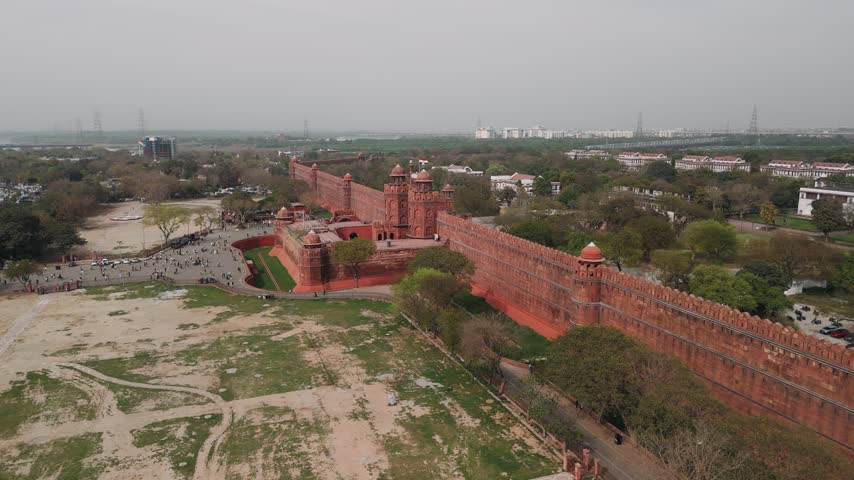 Aerial view of the historic red fort in delhi with the cityscape in the background, a famous landmark of india.