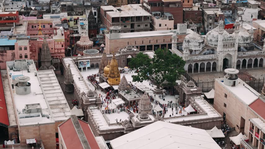 Aerial view of kashi vishwanath temple and gyanvapi mosque in varanasi, india, with crowd of pilgrims visiting.
