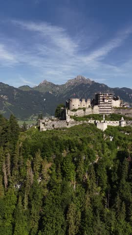 Ehrenberg Castle ruins on a wooded hill near Reutte in Tyrol, Austria aerial drone vertical video