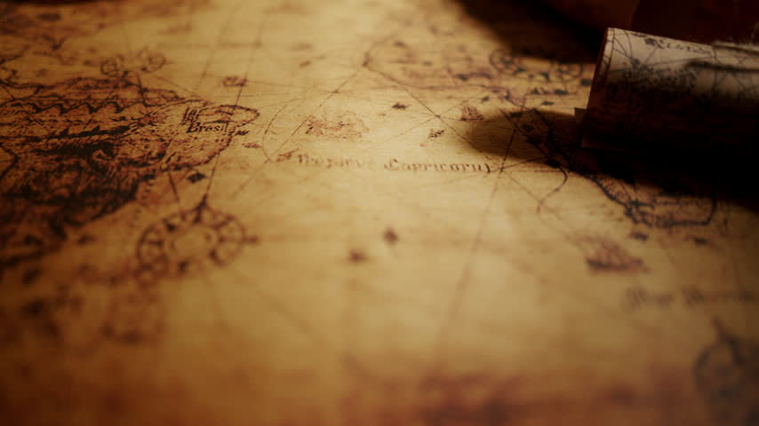 Old parchment map with rolled scroll close up, vintage cartography. History, geography, ancient travel and exploration concept background