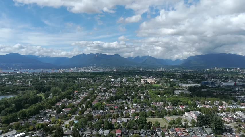 Residential Neighborhood In Vancouver With Mountain Range In The Background In British Columbia, Canada. - aerial hyperlapse shot
