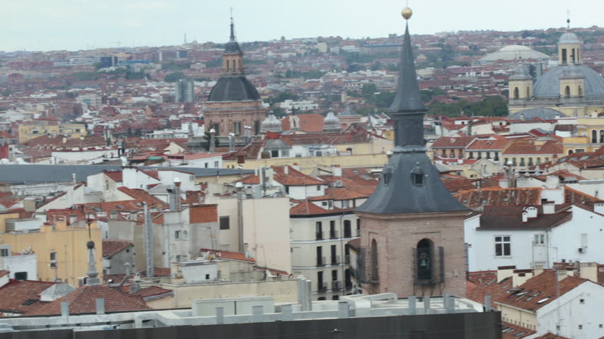 Elevated panoramic view over the historic terracotta rooftops and classic spires of the old town in Madrid, Spain. Urban European cityscape showcasing Spanish architectural heritage