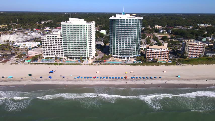 South Carolina resort accommodation faces the Atlantic across a sunlit stretch of sand in Myrtle Beach.

