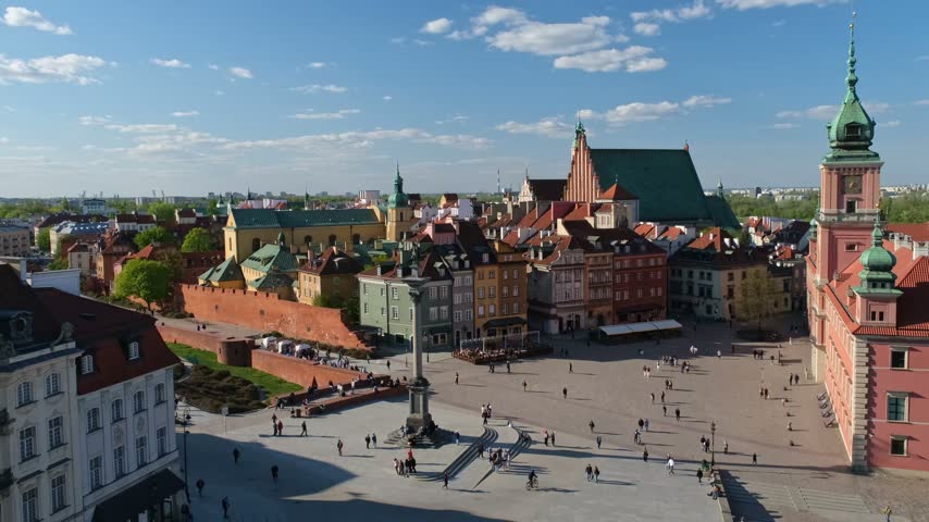 Elevated view of Castle Square in Warsaw Old Town with the Royal Castle, Sigismunds Column, St Johns Archcathedral, historic facades, and pedestrians