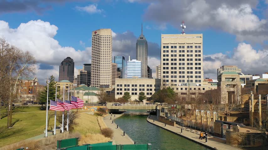 Scenic cityscape featuring modern office buildings skyscrapers and tranquil canal waterway in downtown Indianapolis Indiana.
