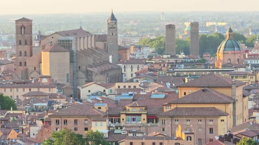 Bologna cityscape and skyline featuring the iconic medieval Asinelli Tower and Garisenda Tower, in historic buildings and terracotta rooftops in Italy with Basilica Saint Petronius patron of Bologna
