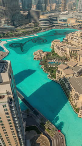 Turquoise artificial lake daytime aerial timelapse located in Downtown Dubai. Top-down view of the turquoise artificial lake highlighting the complex fountain structures.