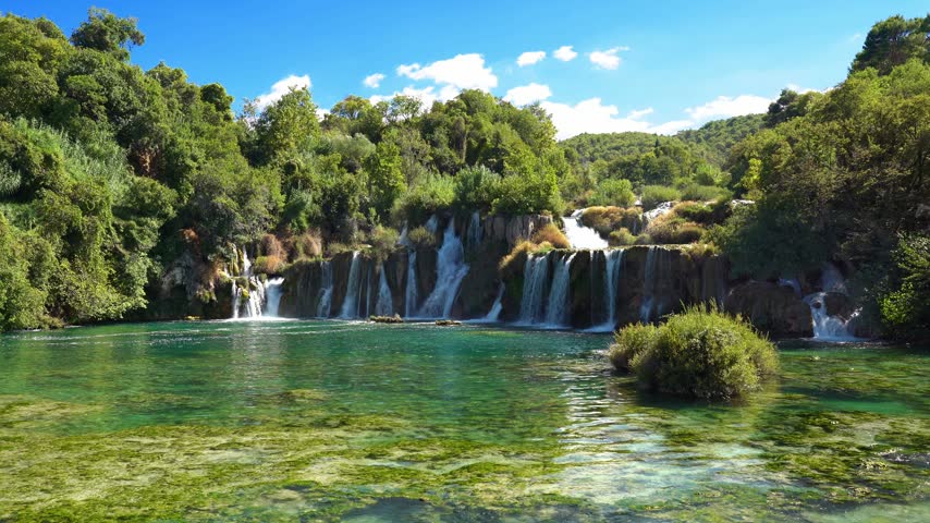 Beautiful waterfall in Krka National Park, Croatia, with lush green forest and crystal clear turquoise water