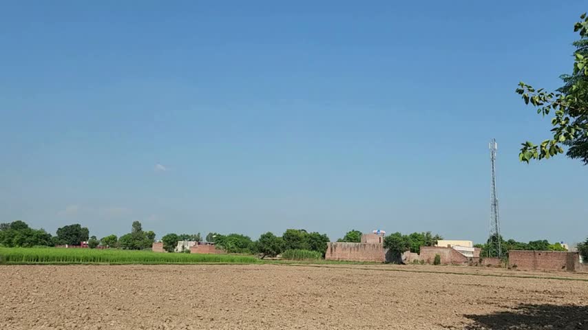 Blue sky above rural agricultural landscape. Clear blue sky over open agricultural countryside and distant farmland.