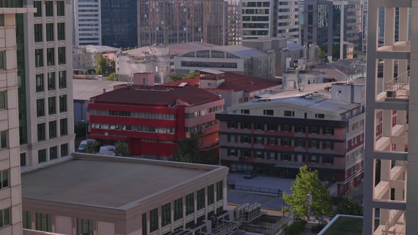 Urban view of a predominantly commercial district in Umraniye, Istanbul, featuring modern skyscrapers, medium sized office buildings, corporate headquarters and business properties. The dense cityscape represents Istanbul