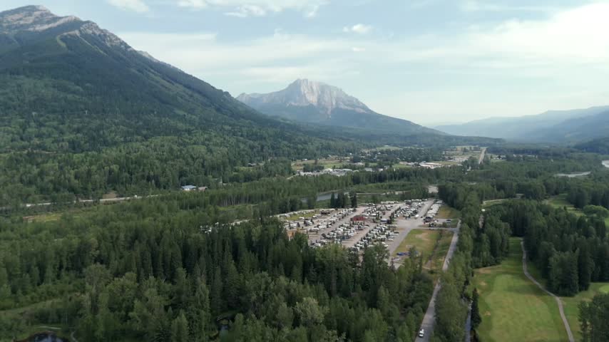 RVs At Fernie RV Resort, Camppground By The Elk River In Fernie, BC, Canada. - aerial shot
