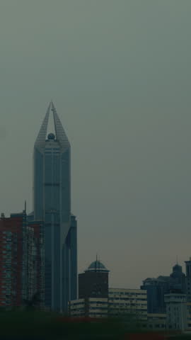 Shanghai Urban Landscape from Vehicle
Modern skyscrapers and residential buildings seen while traveling along the streets of Shanghai.