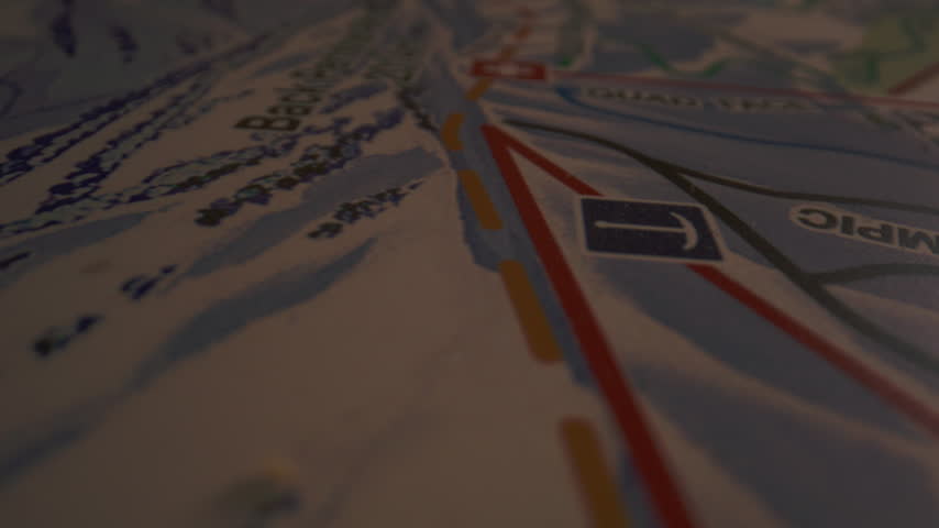 Medical cross marks a ski patrol location among colored routes on a resort trail map
