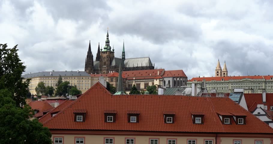 Prague Castle viewed above rooftops in Czechia on a cloudy day