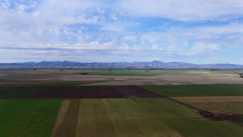 Aerial view of dramatic cloudy sky over farmland fields near Sierra de la Ventana, Argentina.