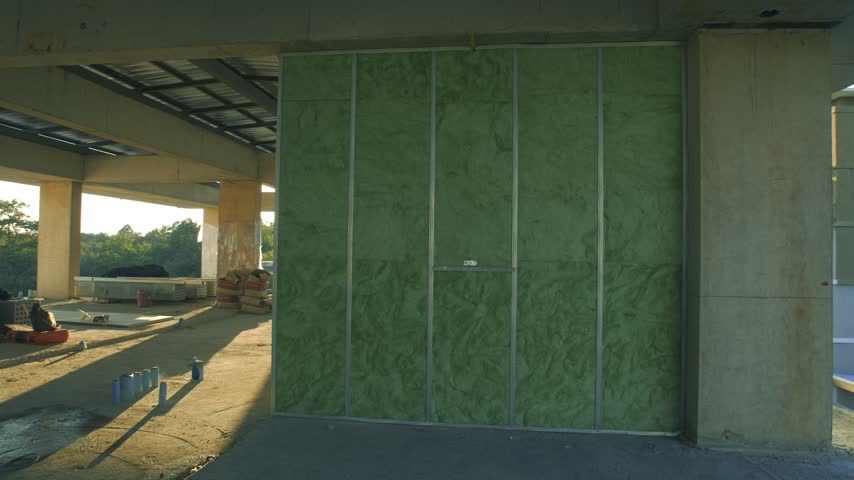 A wide interior shot of a soundproof wall panel installation at a construction site