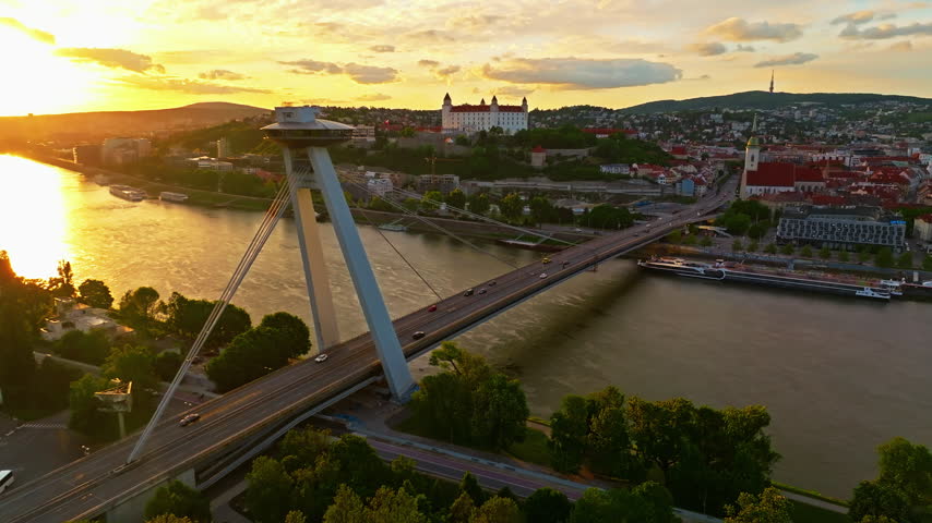 Aerial view of beautiful view of the Danube River and the bridge in the center of Bratislava at sunset, Slovakia