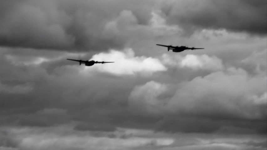 Two Consolidated B-24 Liberators from WWII flying in formation. Clip treated to