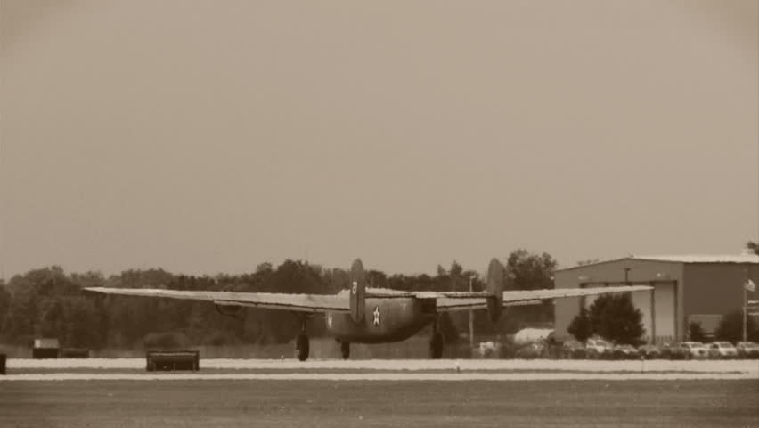 Two Consolidated B-24 Liberators from WWII taking off in formation. Clip treated